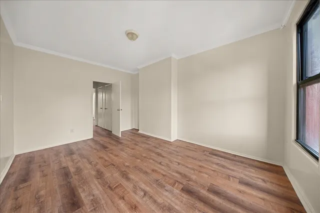 an empty room with windows and closet