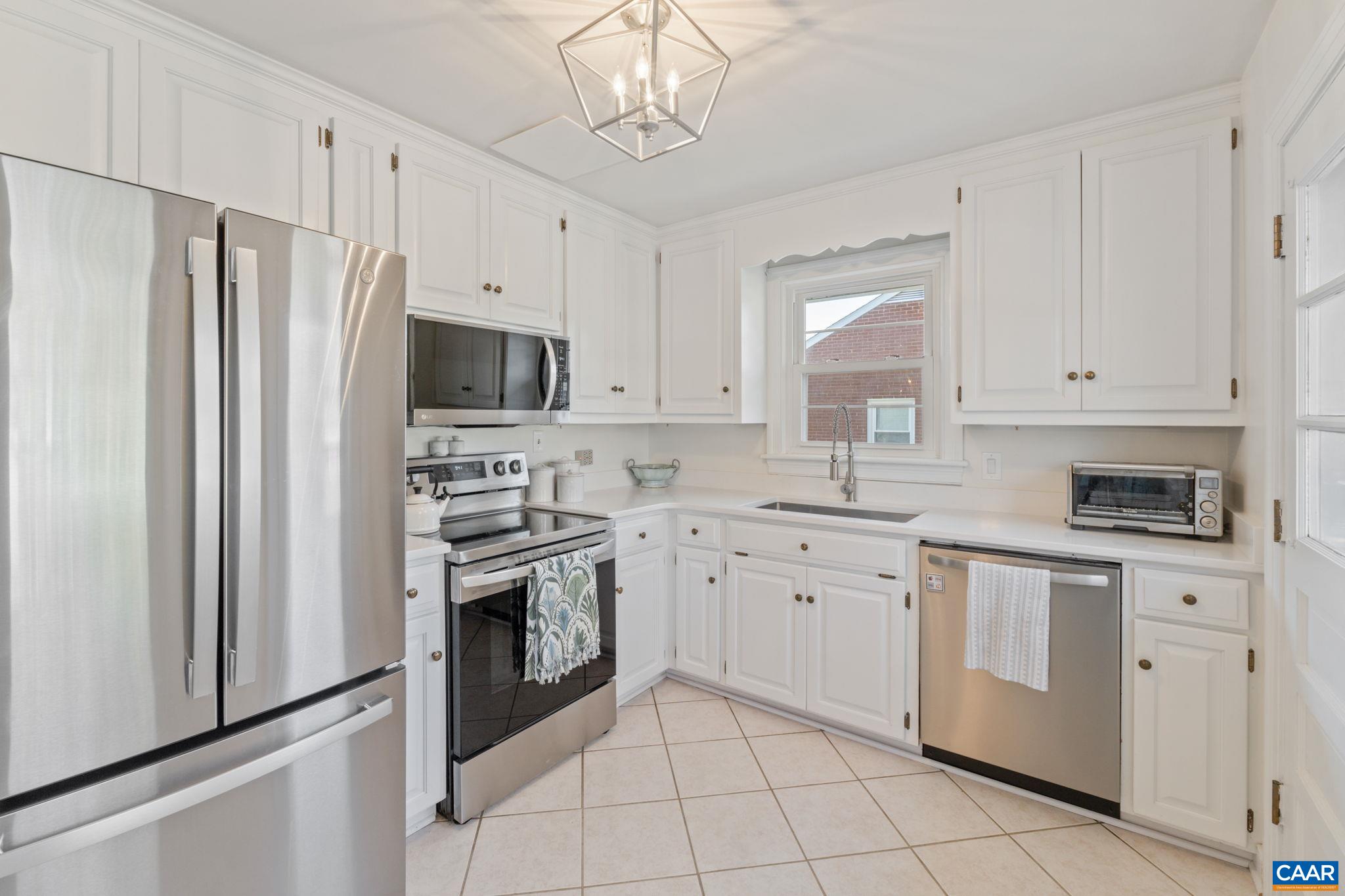 109 Camellia Drive Charlottesville, VA 22903 - Photo 14 of 49 a kitchen with white cabinets stainless steel appliances and a window