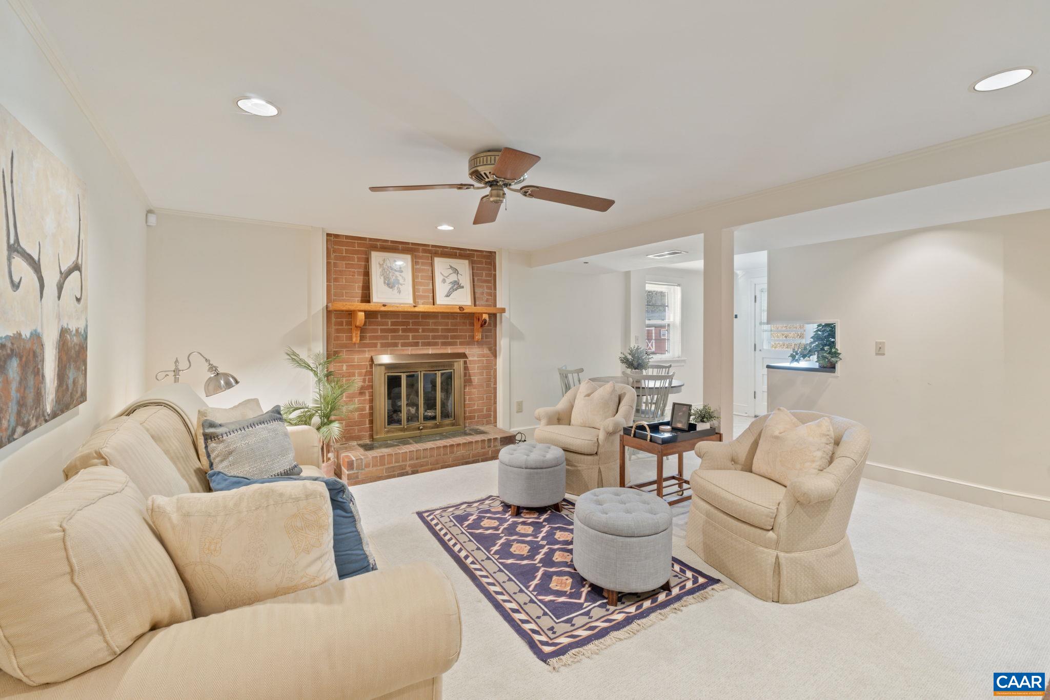 109 Camellia Drive Charlottesville, VA 22903 - Photo 22 of 49 a living room with furniture a fireplace and a chandelier