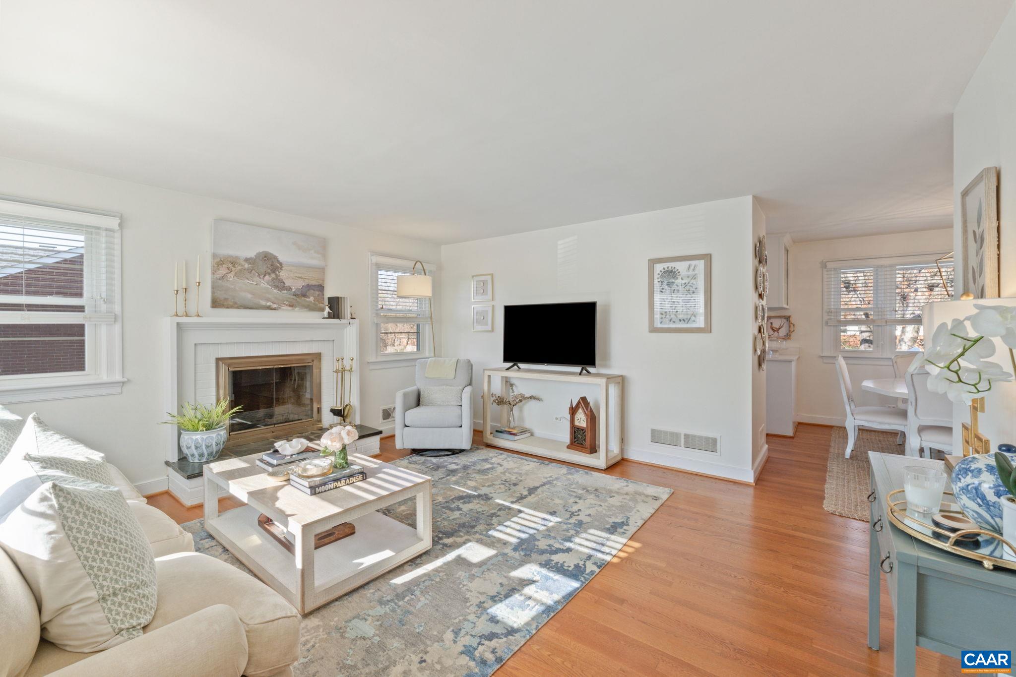 109 Camellia Drive Charlottesville, VA 22903 - Photo 8 of 49 a living room with furniture a flat screen tv and a fireplace