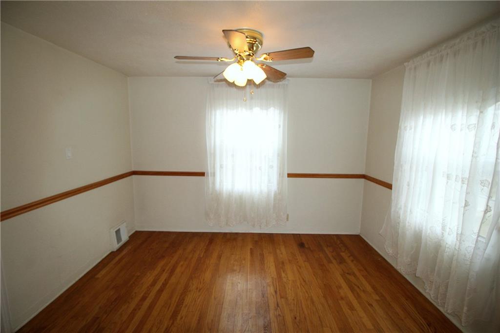 835 Middle Road Pittsburgh, PA 15234 - Photo 5 of 21 The hardwood floors continue into the dining room accented with a chair rail.