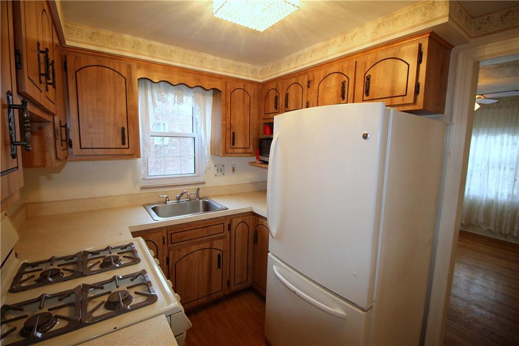 835 Middle Road Pittsburgh, PA 15234 - Photo 7 of 21 Efficient kitchen includes the gas range, refrigerator and a microwave oven.