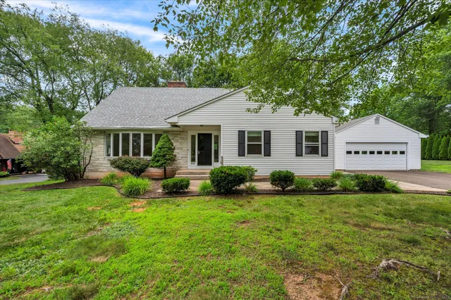 a view of a house with a backyard