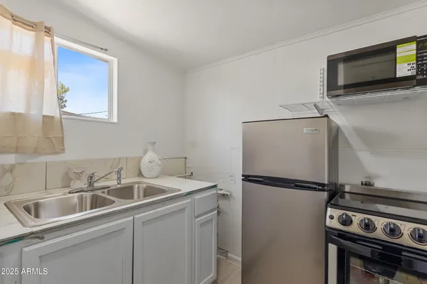 a kitchen with a refrigerator and a sink
