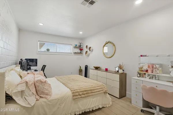 a bedroom with bed and a chandelier
