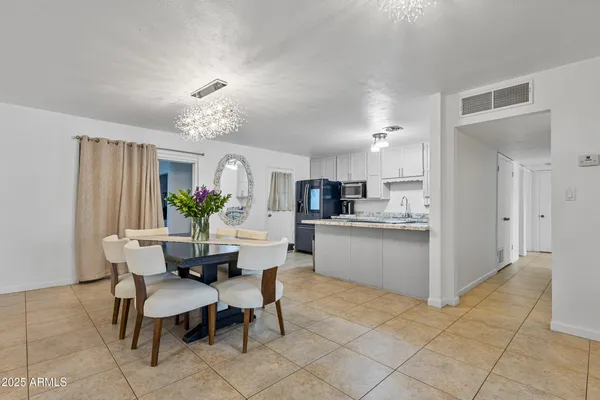a view of kitchen with refrigerator and dining table