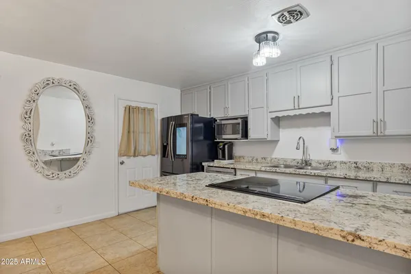 a kitchen with a sink cabinets and window