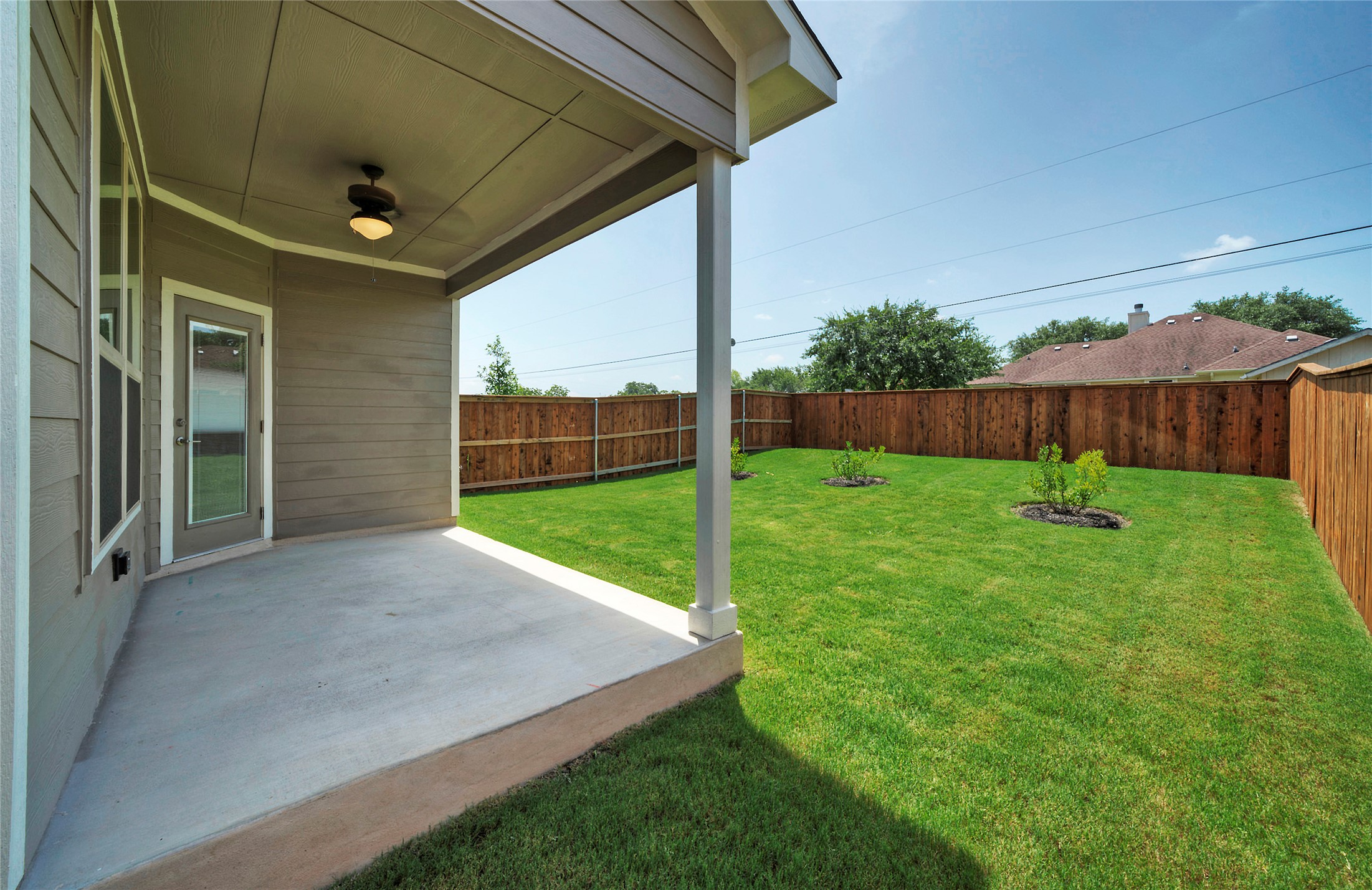 508 High Tech Drive, Unit B Georgetown, TX 78626 - Photo 24 of 24 An inviting covered patio offers a comfortable outdoor space, extending to a private fenced yard with lush lawn.