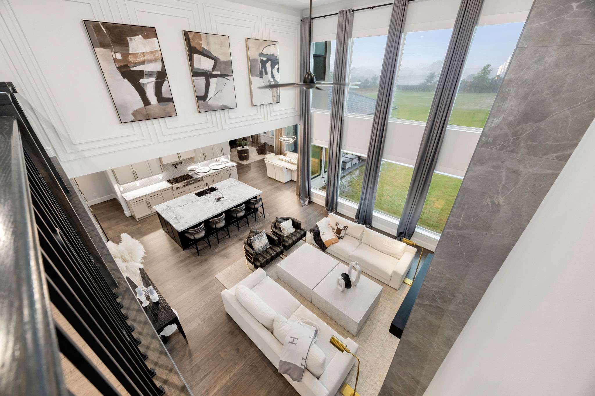 29419 Cir S Rnch Trail Fulshear, TX 77406 - Photo 7 of 45 Things We Love #5- Looking down from the second-floor catwalk layout gives an impressive overview of the open-concept kitchen and the double-height family room framing the expansive backyard views.