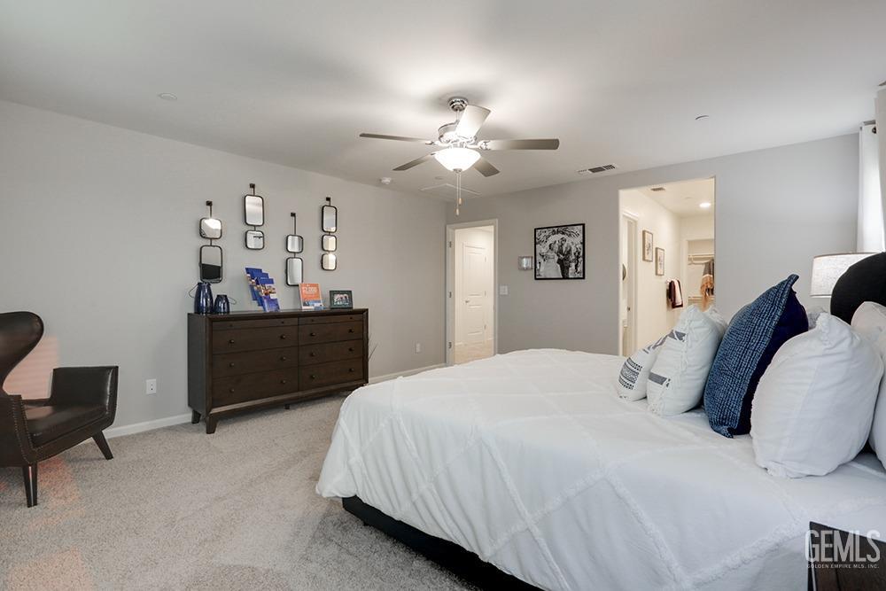 Undisclosed Address Bakersfield, CA 93313 - Photo 17 of 30 a bedroom with a bed and a chandelier