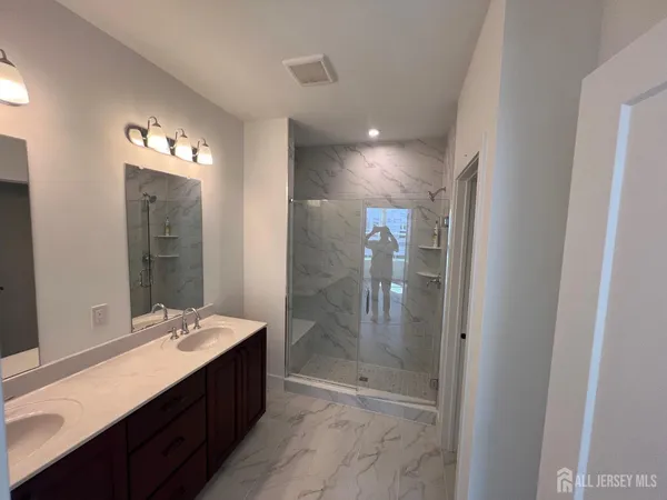 a bathroom with a sink vanity mirror and toilet
