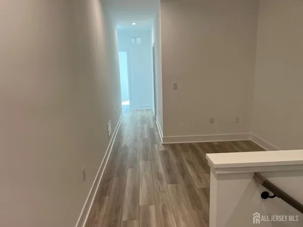 a view of hallway with a wooden floor
