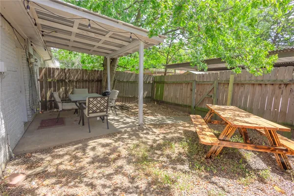 a view of a backyard with a patio and outdoor seating