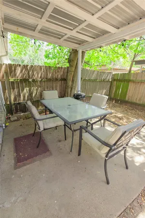 a patio with table and chairs