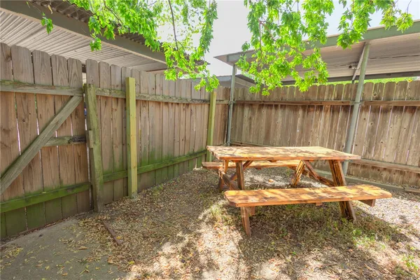 a view of a backyard with a small cabin and a chair