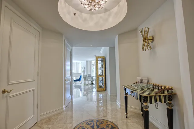 a view of a hallway to a livingroom with furniture