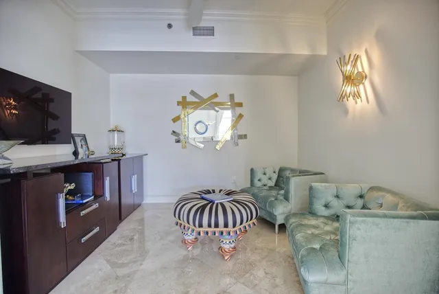 a bedroom with furniture and a flat screen tv