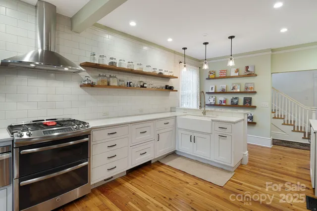a kitchen with cabinets appliances and a wooden floor