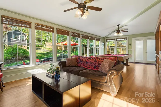 a living room with furniture and large windows