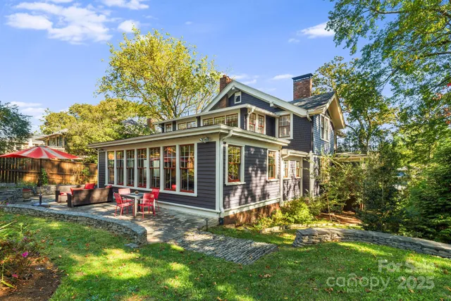 a view of a house with a yard and potted plants
