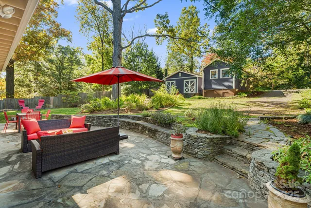 a backyard of a house with yard and outdoor seating
