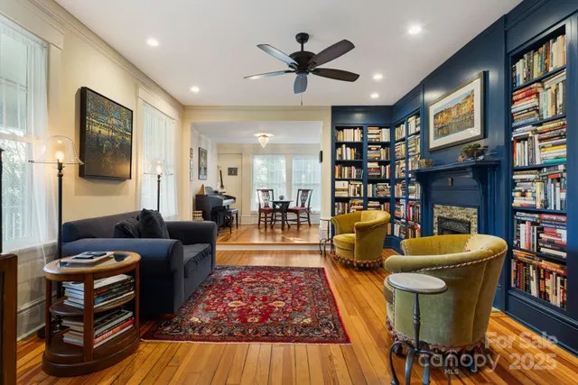 a living room with fireplace furniture and a book shelf