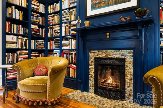 a living room with furniture a rug and a fireplace
