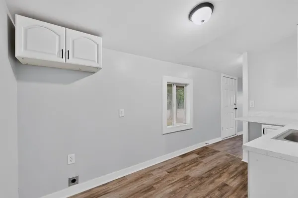 a room with a sink and a wooden floor