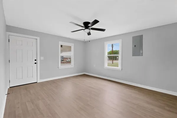 a living room with furniture a ceiling fan and a window