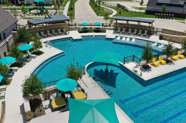 an aerial view of a house with a swimming pool patio and outdoor seating