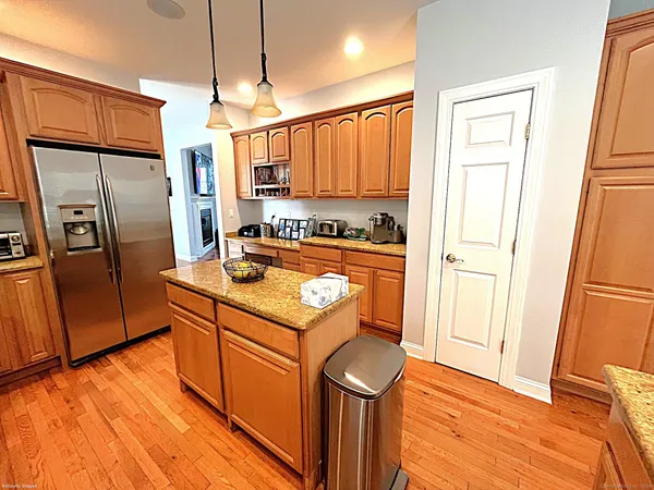 a kitchen with stainless steel appliances granite countertop a refrigerator a sink and a stove