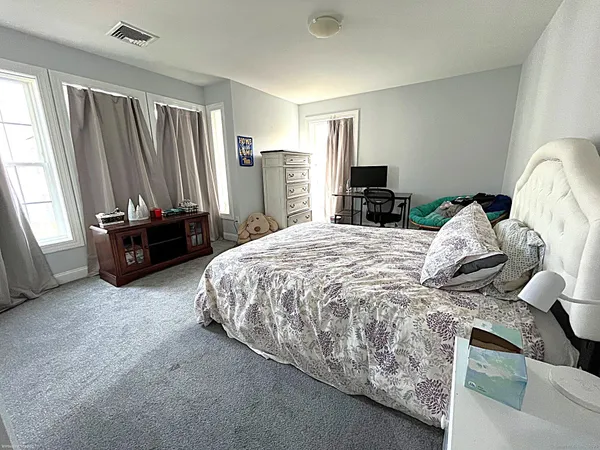 a bedroom with a bed and a couch