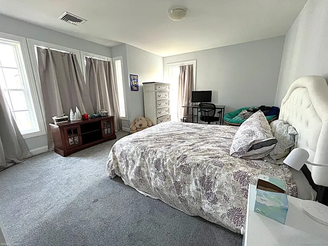 a bedroom with a bed and a couch