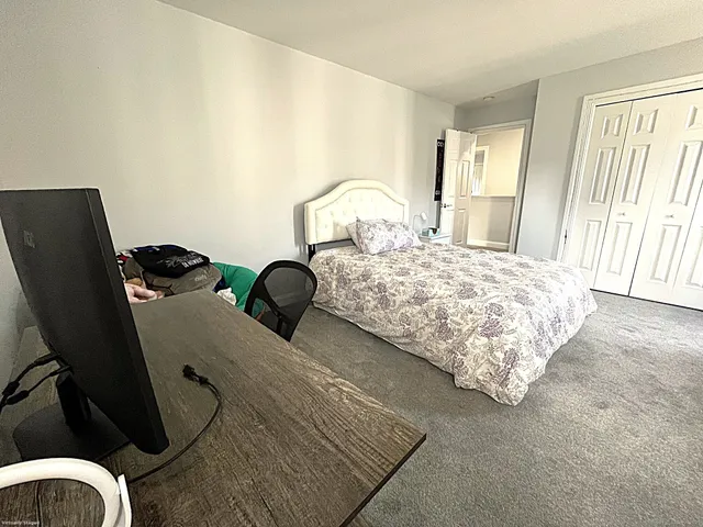 a bedroom with bed and window