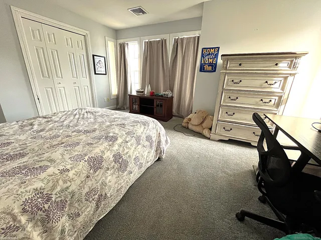 a bedroom with a bed and a closet