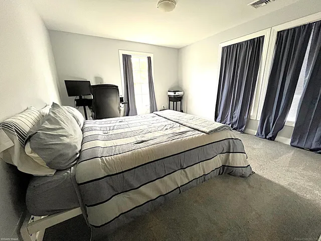 a bedroom with a bed and window