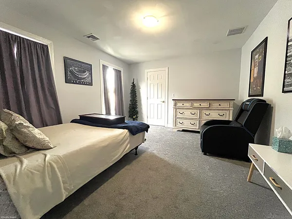 a bedroom with a bed and a couch