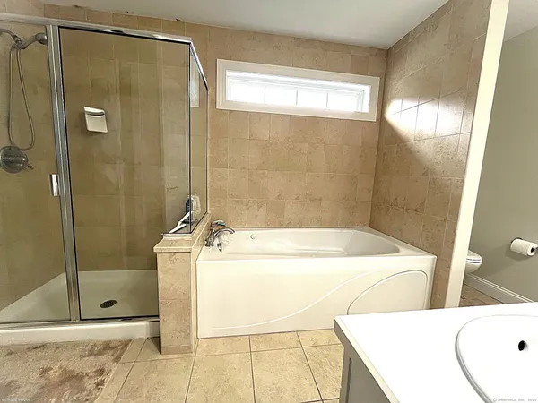 a bathroom with a sink a shower and a mirror