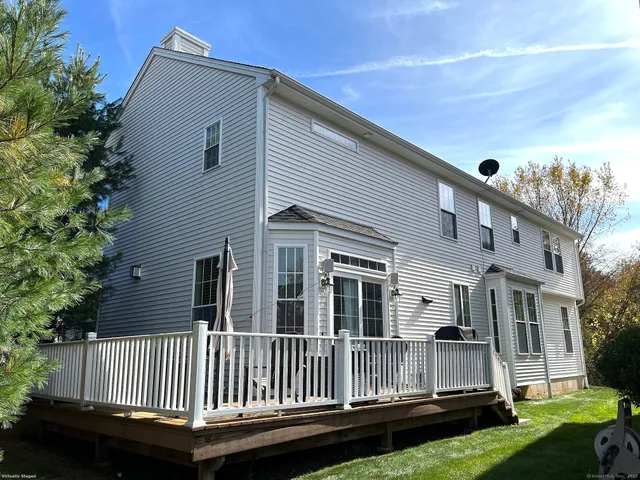 a view of a house with a yard and deck