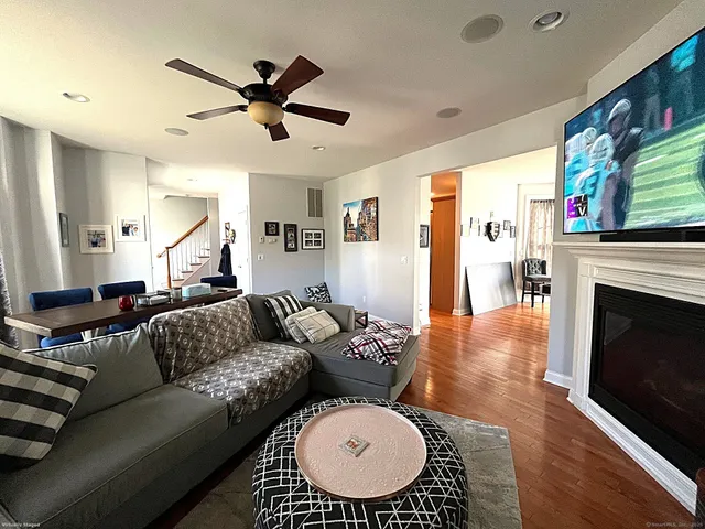 a living room with furniture a fireplace and a chandelier