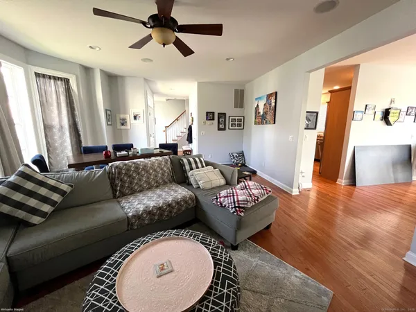 a living room with furniture and a wooden floor