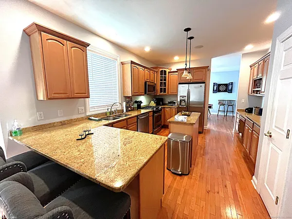 a kitchen with stainless steel appliances granite countertop sink stove top oven and cabinets