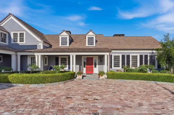a large kitchen with stainless steel appliances granite countertop a large counter top a stove and a sink