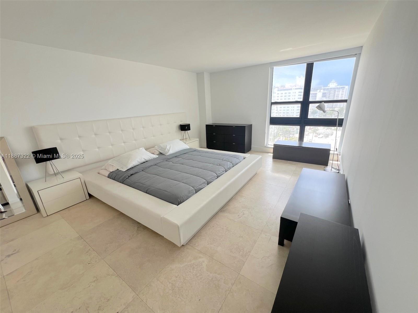 1800 Collins Avenue, Unit 12E Miami Beach, FL 33139 - Photo 13 of 17 a bedroom with a bed and a window