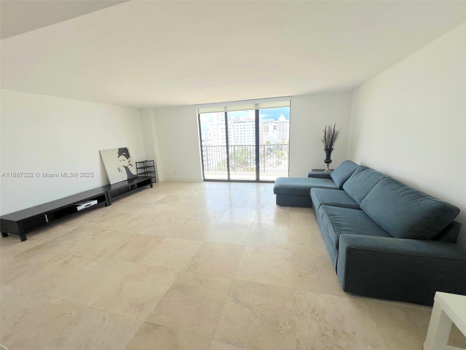 1800 Collins Avenue, Unit 12E Miami Beach, FL 33139 - Photo 5 of 17 a living room with furniture and a window