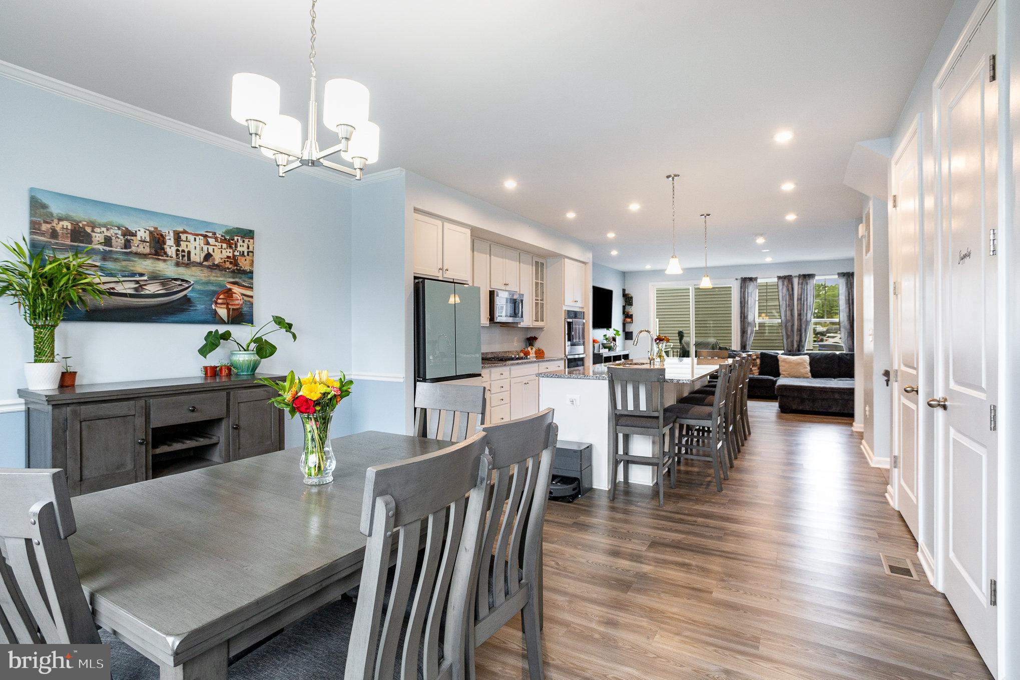 18236 Summit Pointe Drive Triangle, VA 22172 - Photo 12 of 36 a dining room with furniture a chandelier and wooden floor