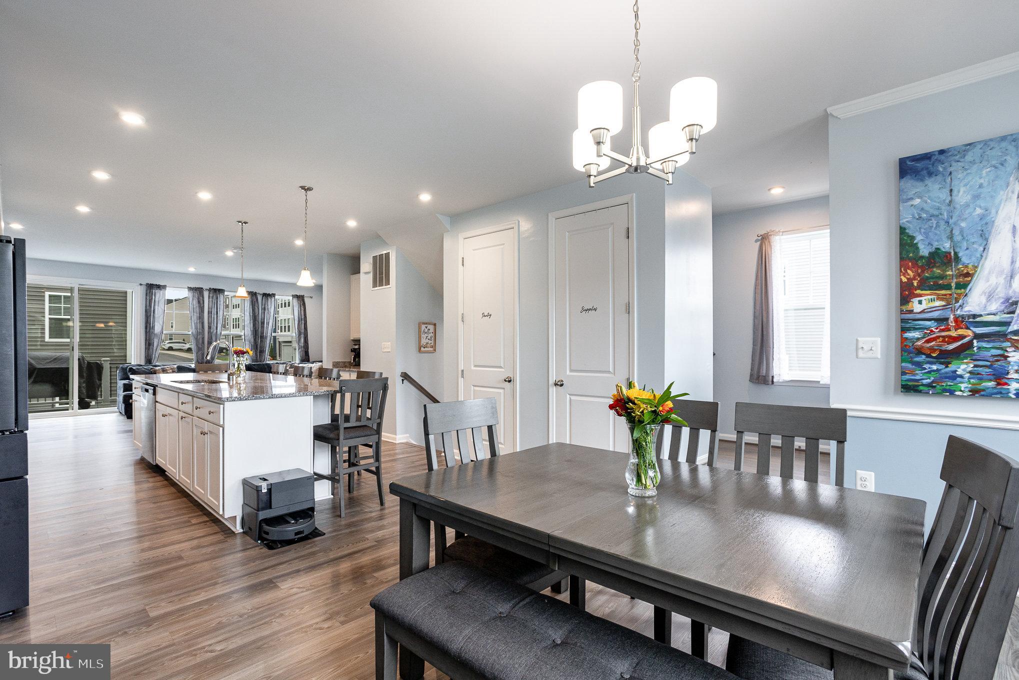 18236 Summit Pointe Drive Triangle, VA 22172 - Photo 13 of 36 a large dining space with furniture a chandelier and wooden floor