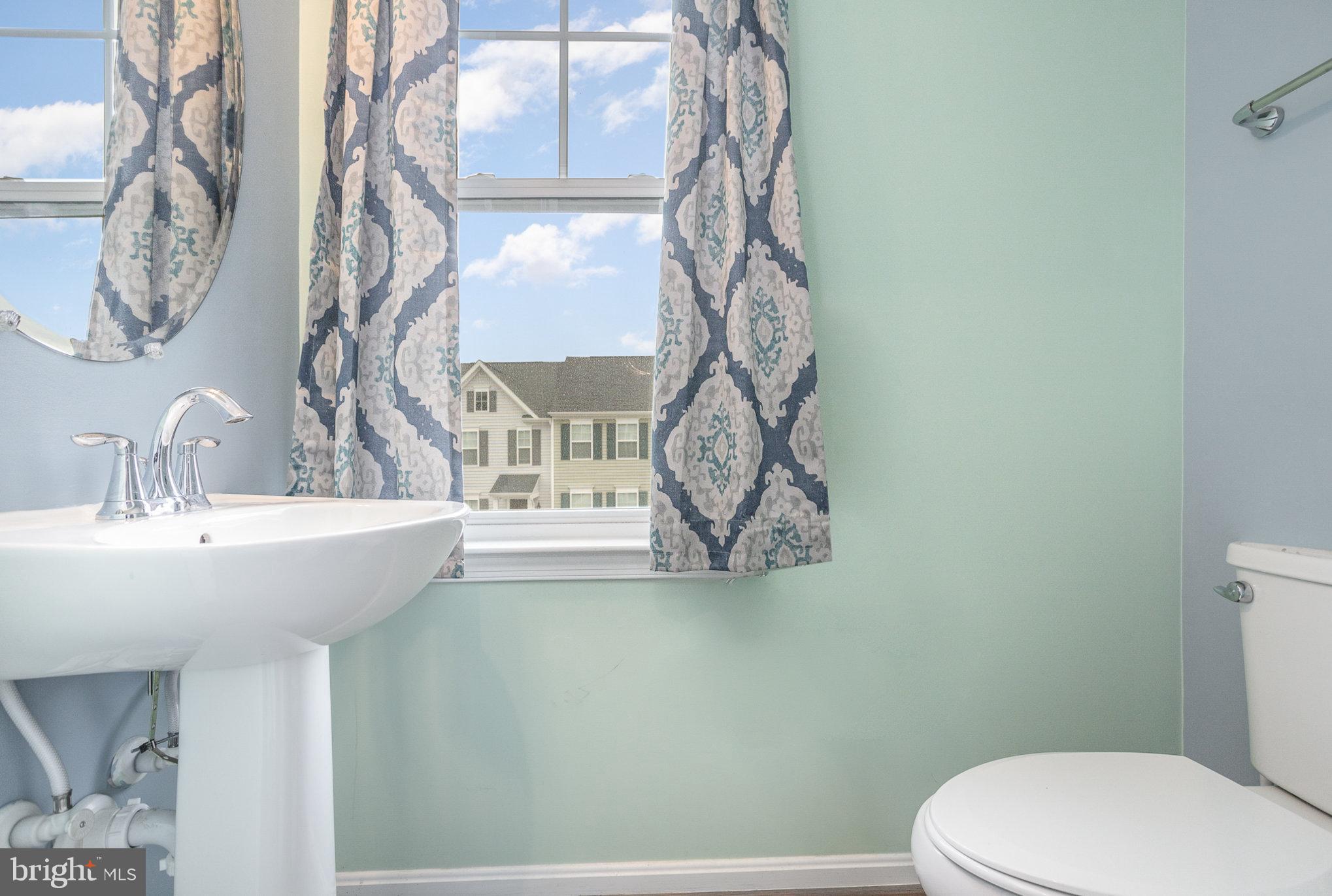 18236 Summit Pointe Drive Triangle, VA 22172 - Photo 18 of 36 a bathroom with a toilet sink and mirror