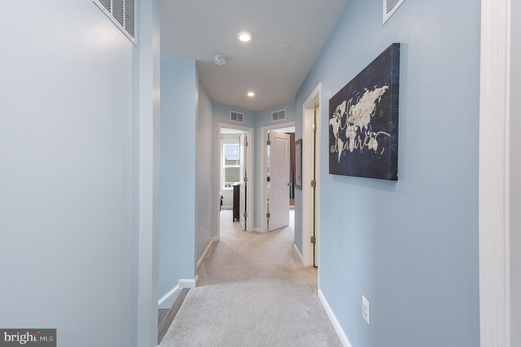 18236 Summit Pointe Drive Triangle, VA 22172 - Photo 21 of 36 a view of a hallway with paintings on the wall