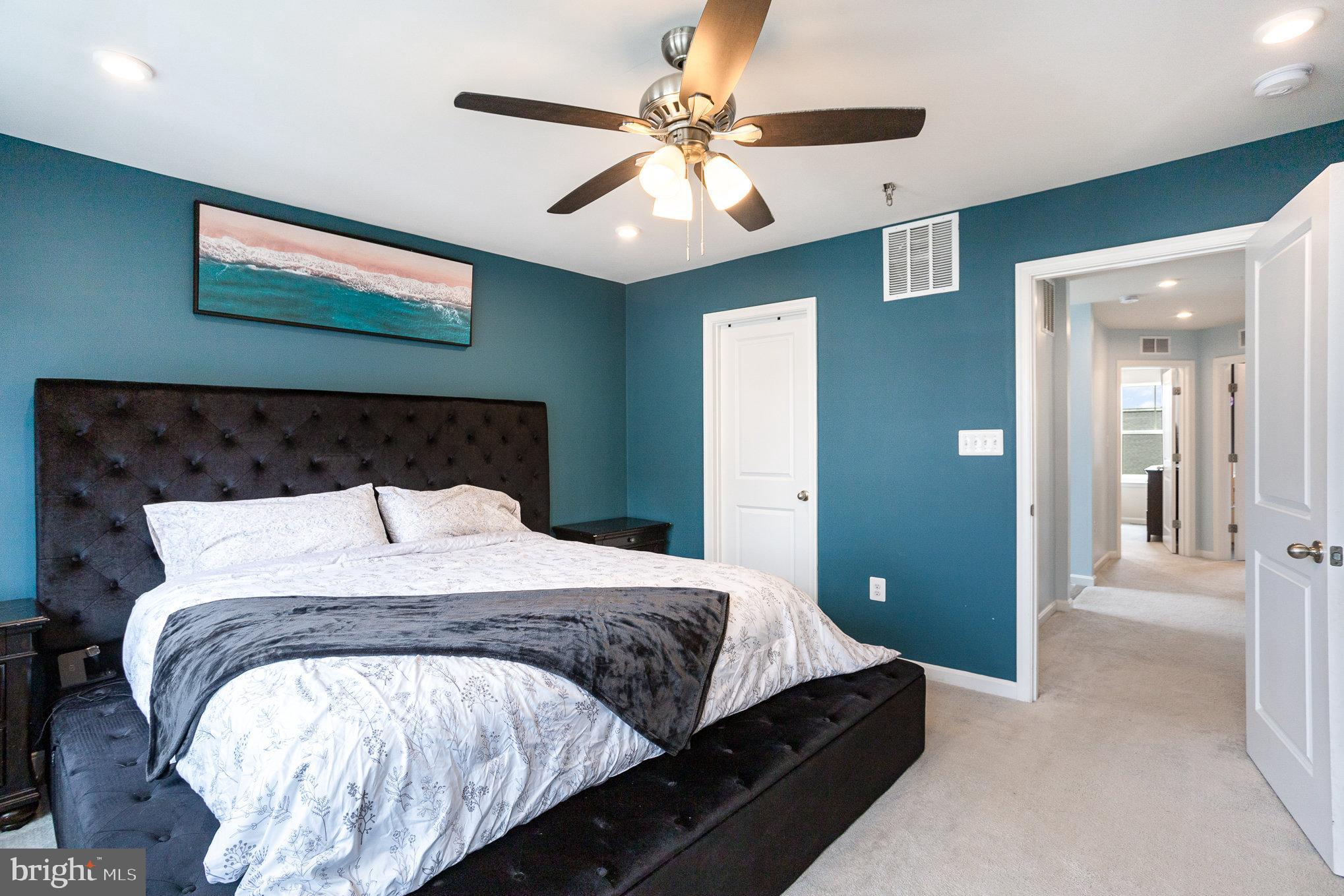 18236 Summit Pointe Drive Triangle, VA 22172 - Photo 23 of 36 a bedroom with bed and a chandelier